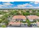 Sprawling aerial view of condo community with lush trees and landscaping and plenty of parking at 10202 L Pavia Blvd # 10202, Venice, FL 34292