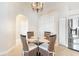 Cozy dining area with a glass table, seating for four, and a chandelier at 10202 L Pavia Blvd # 10202, Venice, FL 34292