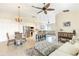 Open concept living room featuring a dining table, kitchen area, and comfortable seating at 10202 L Pavia Blvd # 10202, Venice, FL 34292