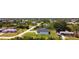 Aerial shot of a neighborhood featuring a modern home with a well-manicured lawn and mature trees at 10588 Kidron Ave, Englewood, FL 34224
