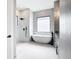 Spa-like bathroom features large soaking tub, double shower, and stylish vanity with granite counters at 10588 Kidron Ave, Englewood, FL 34224