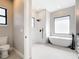 Beautiful bathroom featuring soaking tub, sleek fixtures, shower with marble surround and vanity at 10588 Kidron Ave, Englewood, FL 34224