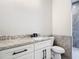 Bathroom with a white vanity cabinet with a granite countertop and sleek fixtures at 10588 Kidron Ave, Englewood, FL 34224