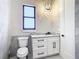 Bathroom with a white vanity cabinet with a granite countertop and sleek fixtures at 10588 Kidron Ave, Englewood, FL 34224