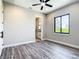 Bedroom with sleek wood flooring, bathroom doorway, and window at 10588 Kidron Ave, Englewood, FL 34224