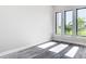 Sunlit bedroom features wood-look floors and large windows offering scenic views at 10588 Kidron Ave, Englewood, FL 34224