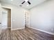 Open bedroom boasts wood-look floors, neutral walls, closet, and ample natural light at 10588 Kidron Ave, Englewood, FL 34224