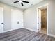 Bedroom featuring sleek wood flooring, walk-in closet, and open doorway to the bathroom at 10588 Kidron Ave, Englewood, FL 34224