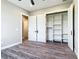 Bedroom featuring sleek wood flooring, walk-in closet, and open doorway to another room at 10588 Kidron Ave, Englewood, FL 34224