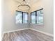 Dining area with modern chandelier and large windows offering natural light at 10588 Kidron Ave, Englewood, FL 34224