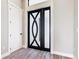 Elegant foyer featuring a modern front door design, stylish flooring, and neutral wall colors at 10588 Kidron Ave, Englewood, FL 34224