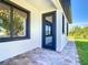 Inviting front entrance with a black-framed window and black front door at 10588 Kidron Ave, Englewood, FL 34224
