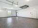 Spacious garage with epoxy flooring, ample lighting, and plenty of room for vehicles and storage at 10588 Kidron Ave, Englewood, FL 34224