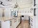 Open kitchen design with island, stainless steel appliances, and white cabinets at 10588 Kidron Ave, Englewood, FL 34224