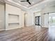 Spacious living area with a striking accent wall, modern flooring, and an elegant front door at 10588 Kidron Ave, Englewood, FL 34224