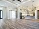 Open-concept living space flowing into a modern kitchen with stainless steel appliances and a breakfast bar at 10588 Kidron Ave, Englewood, FL 34224