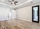 Large main bedroom featuring vinyl flooring and a modern tray ceiling with fan at 10588 Kidron Ave, Englewood, FL 34224