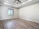 Spacious main bedroom with tray ceiling, modern ceiling fan and vinyl flooring at 10588 Kidron Ave, Englewood, FL 34224