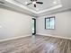 Open main bedroom with a tray ceiling, modern ceiling fan and access to backyard at 10588 Kidron Ave, Englewood, FL 34224