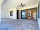 Covered outdoor patio with ceiling fan and decorative paver flooring, perfect for entertaining or relaxing at 10588 Kidron Ave, Englewood, FL 34224