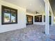 Covered outdoor patio with ceiling fan and decorative paver flooring at 10588 Kidron Ave, Englewood, FL 34224