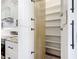 Kitchen pantry with white shelving and easy access to modern appliances at 10588 Kidron Ave, Englewood, FL 34224