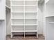 Walk-in closet offering ample storage space with built-in shelving and laminate floor at 10588 Kidron Ave, Englewood, FL 34224