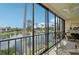 Relaxing enclosed balcony with serene views of the lake and lush greenery, perfect for enjoying the outdoors indoors at 1170 Bird Bay Way # 206, Venice, FL 34285