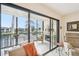 The screened balcony features tile floors, a seating area, and serene views of the surrounding landscape at 1170 Bird Bay Way # 206, Venice, FL 34285