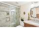 Elegant bathroom with glass shower enclosure and granite counters, seamlessly blending style and comfort at 1170 Bird Bay Way # 206, Venice, FL 34285
