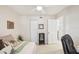 View of a bedroom showcasing a bed with decorative pillows, mirrored cabinet, and closet doors at 1170 Bird Bay Way # 206, Venice, FL 34285