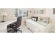 Bedroom featuring a daybed with decorative pillows, a desk, and a window with plantation shutters at 1170 Bird Bay Way # 206, Venice, FL 34285