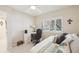 Bedroom featuring a daybed with decorative pillows, a desk, and a window with plantation shutters at 1170 Bird Bay Way # 206, Venice, FL 34285