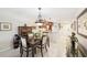 Inviting dining space featuring modern lighting, an open kitchen, and neutral decor at 1170 Bird Bay Way # 206, Venice, FL 34285