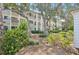 Attractive exterior view surrounded by lush landscaping and mature trees at 1170 Bird Bay Way # 206, Venice, FL 34285