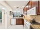 Well-lit kitchen with stainless steel appliances and stone countertops at 1170 Bird Bay Way # 206, Venice, FL 34285