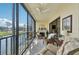 Enclosed lanai featuring a fireplace, comfortable seating, and scenic lake views, perfect for relaxation at 1170 Bird Bay Way # 206, Venice, FL 34285