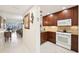Open floorplan showcases kitchen leading to living room and sliding glass doors at 1170 Bird Bay Way # 206, Venice, FL 34285
