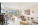 Bright living room boasts neutral tones, tile floors, and a sliding glass door leading to an outdoor view at 1170 Bird Bay Way # 206, Venice, FL 34285