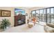 Comfortable living room with an electric fireplace, tile flooring, and views of the screened-in balcony at 1170 Bird Bay Way # 206, Venice, FL 34285