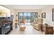 Welcoming living room with tile flooring, a fireplace, and balcony access with views of the yard at 1170 Bird Bay Way # 206, Venice, FL 34285