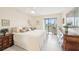Bright main bedroom with neutral walls, tile floors, and a sliding glass door for outdoor views at 1170 Bird Bay Way # 206, Venice, FL 34285