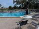 Community pool with lounge chairs and tables, perfect for relaxing and enjoying the Florida sunshine at 1170 Bird Bay Way # 206, Venice, FL 34285