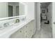 Well-lit bathroom boasts double vanity with marble countertop, soft-close drawers, and a modern, oversized LED mirror at 1212 Princeton Ave, Bradenton, FL 34207