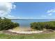 Picturesque beach area with calm waters and surrounding greenery, creating a relaxing coastal environment at 1212 Princeton Ave, Bradenton, FL 34207