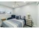 This bedroom has a ceiling fan, window, and a lift chair at 1212 Princeton Ave, Bradenton, FL 34207