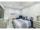 This bedroom has a ceiling fan, window, and a lift chair at 1212 Princeton Ave, Bradenton, FL 34207