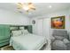 This bedroom features a ceiling fan, closet, and lift chair at 1212 Princeton Ave, Bradenton, FL 34207