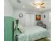 This bedroom features a ceiling fan, closet, and lift chair at 1212 Princeton Ave, Bradenton, FL 34207