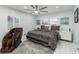 This bedroom has a ceiling fan, a massage chair, and 2 windows at 1212 Princeton Ave, Bradenton, FL 34207